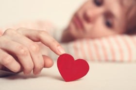 Sad Girl Is Holding Heart Symbol By Her Finger